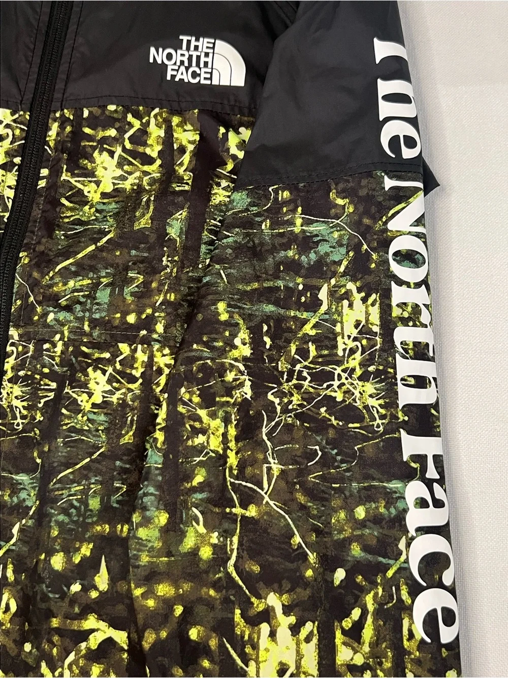 The North Face Kids Black Hooded Rain Jacket with Neon Green Print